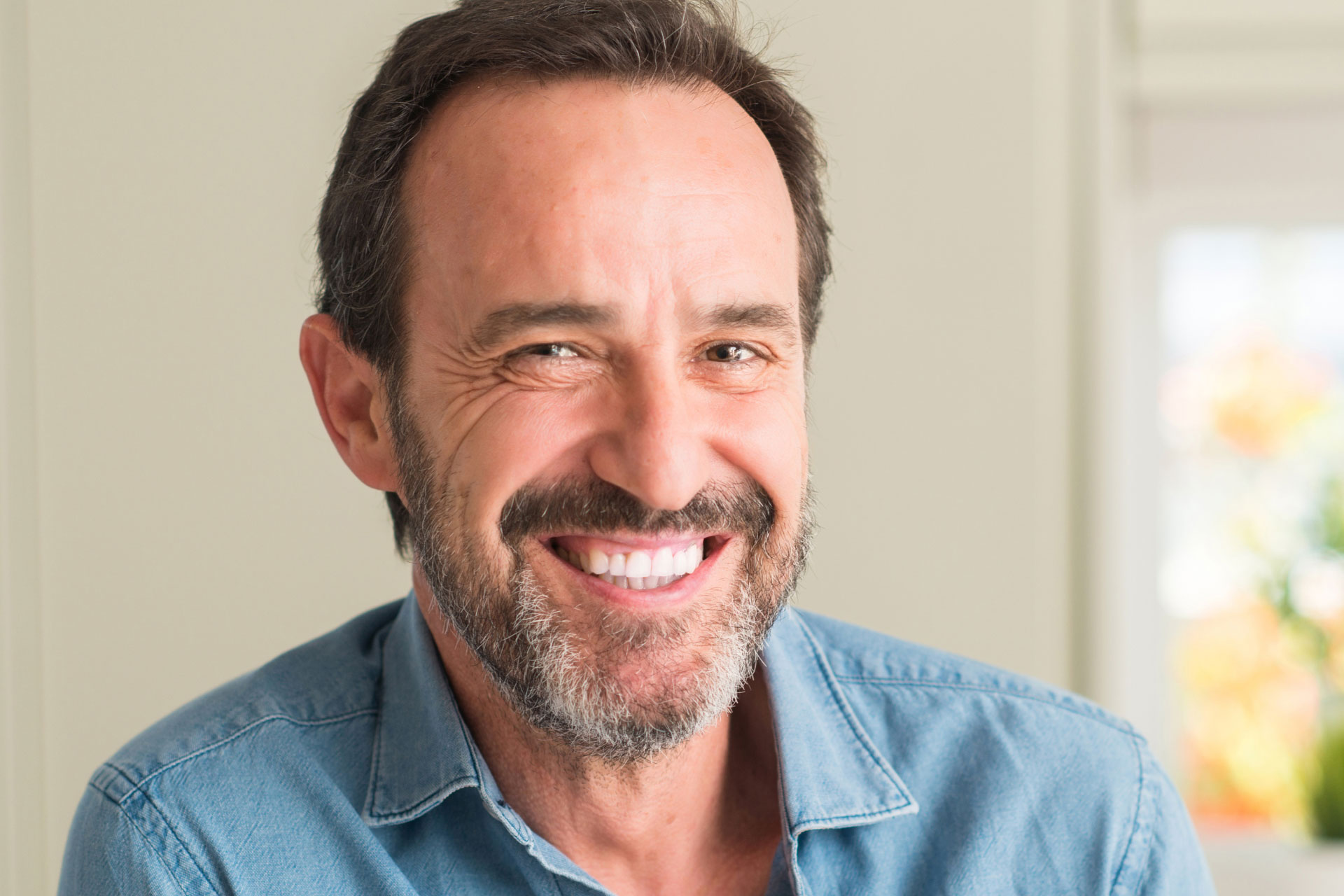 mature man with beard smiling at the camera